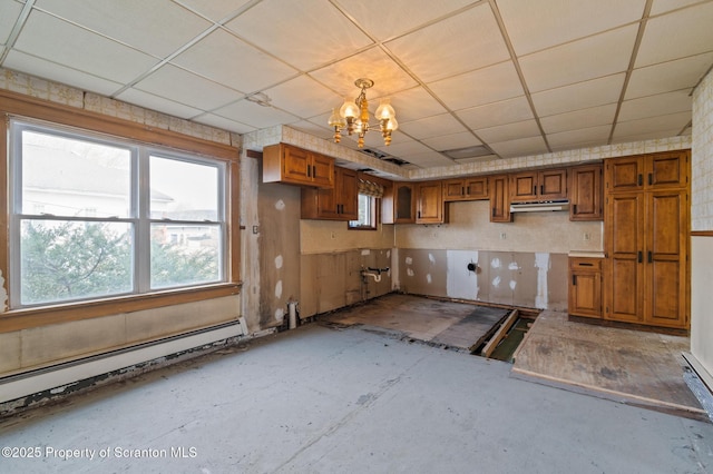 347 Orchard St, Old Forge, PA 18518 - kitchen featuring baseboard heating, brown cabinets, a notable chandelier, and a drop ceiling