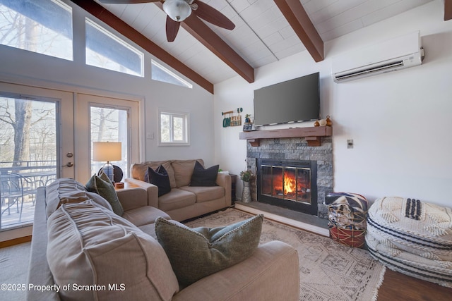 living room with french doors, a wall mounted AC, lofted ceiling with beams, a fireplace, and hardwood / wood-style floors