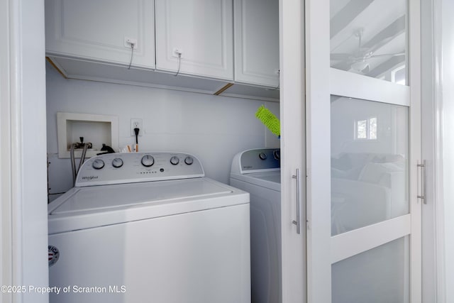 washroom featuring cabinets, washing machine and clothes dryer, and ceiling fan