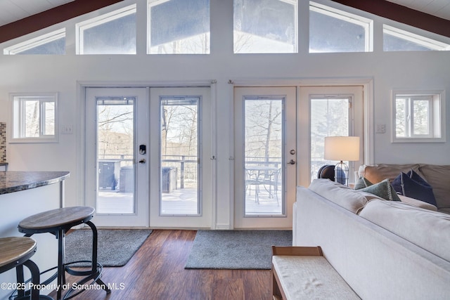 entryway with french doors, dark hardwood / wood-style flooring, and lofted ceiling with beams