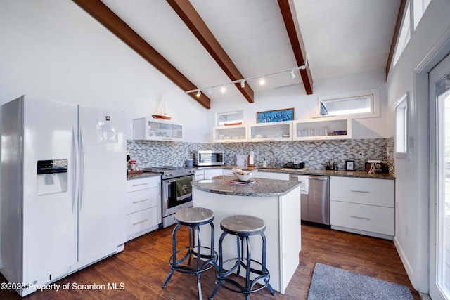 kitchen with tasteful backsplash, a center island, appliances with stainless steel finishes, dark hardwood / wood-style flooring, and white cabinets