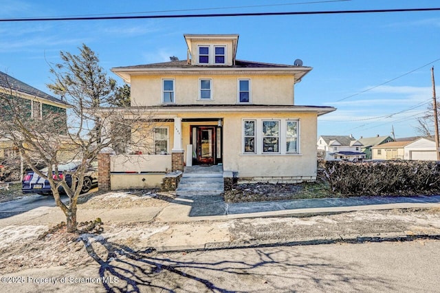 american foursquare style home with stucco siding