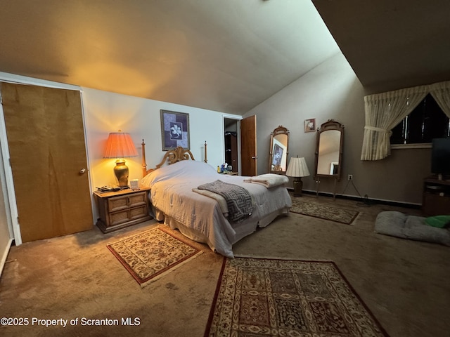 bedroom featuring lofted ceiling and carpet flooring