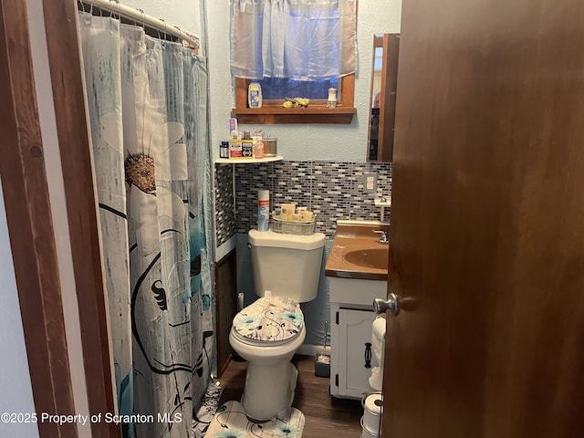 bathroom featuring toilet, a shower with curtain, tile walls, vanity, and hardwood / wood-style flooring