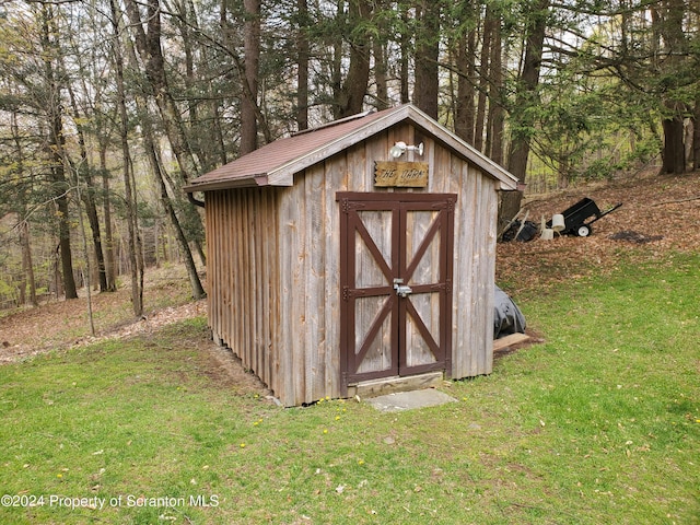 view of outbuilding with a lawn