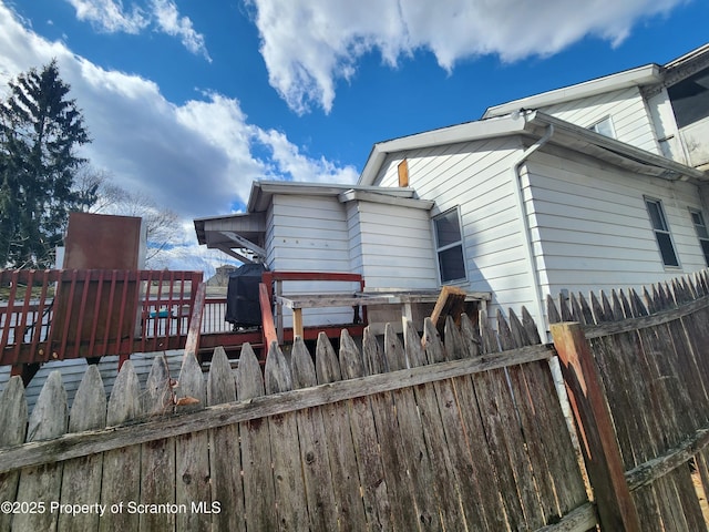 back of house featuring fence