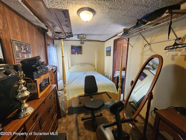 bedroom featuring wooden walls