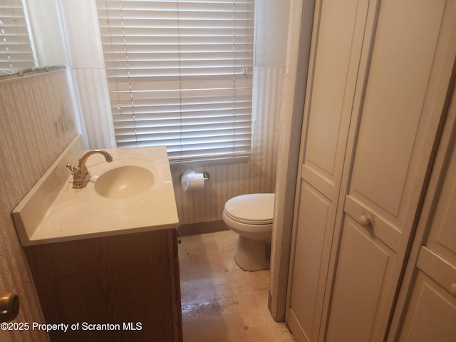 bathroom featuring toilet and vanity