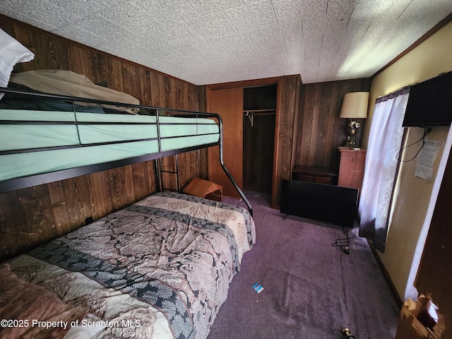 bedroom with a closet, carpet, and wooden walls