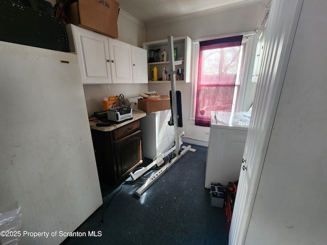 kitchen featuring open shelves, washer / clothes dryer, light countertops, and white cabinetry