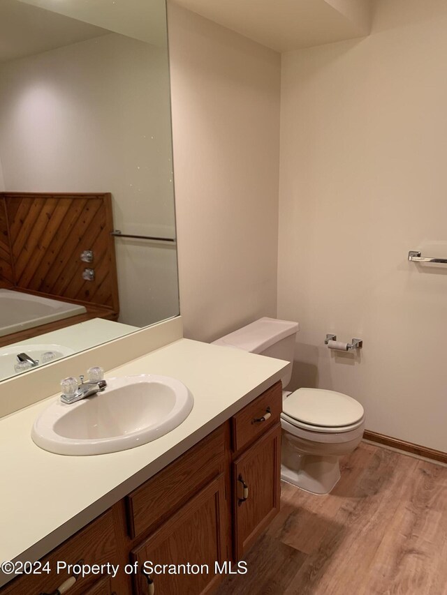 bathroom featuring hardwood / wood-style floors, vanity, and toilet