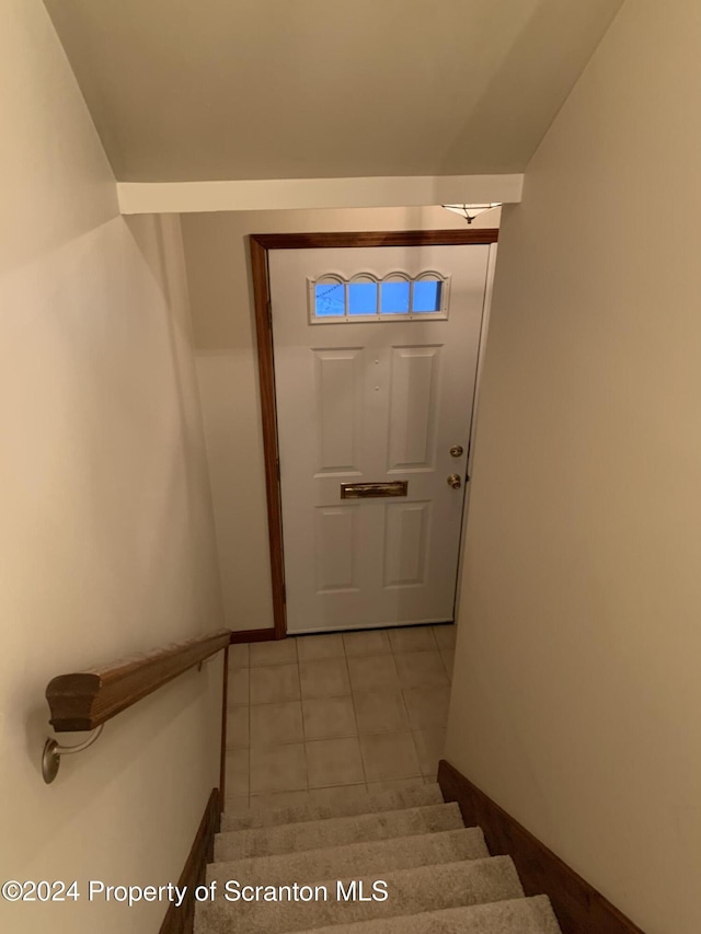 doorway with light tile patterned flooring