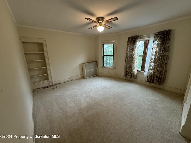 unfurnished bedroom with ceiling fan, light carpet, and ornamental molding