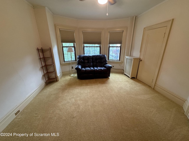 unfurnished room with ceiling fan and light carpet