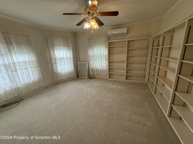 spare room with carpet floors, a wall unit AC, ceiling fan, and crown molding