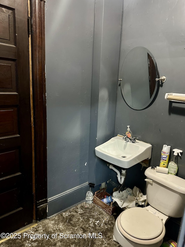 bathroom featuring sink and toilet