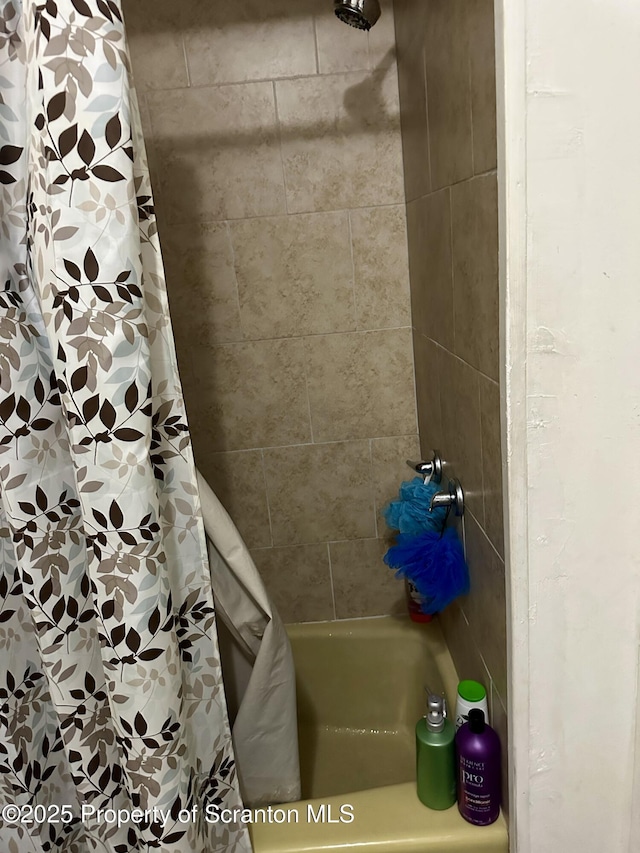 bathroom with shower / bath combination with curtain