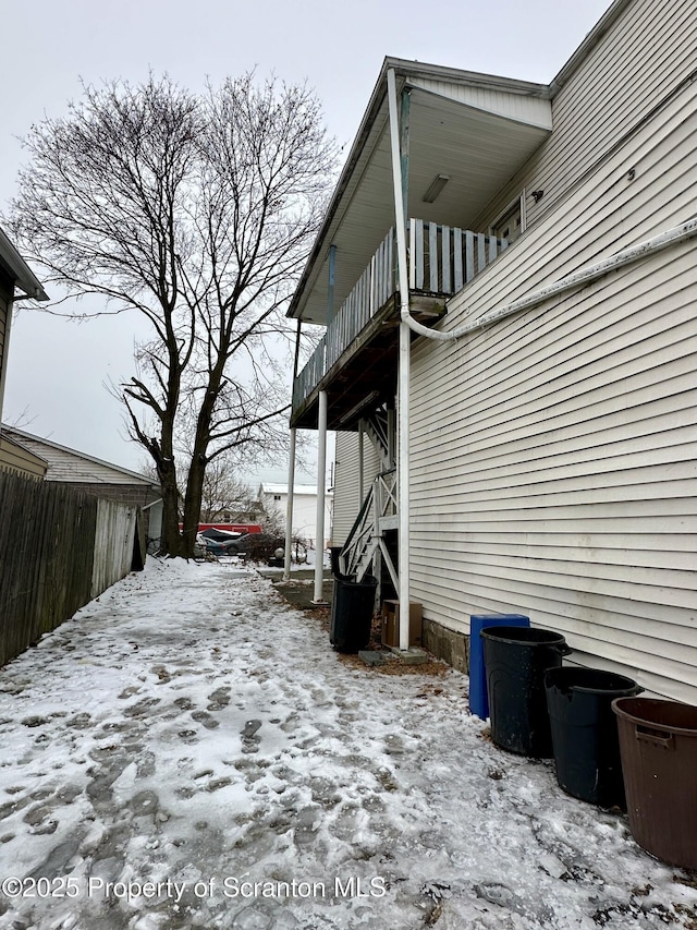 view of snow covered exterior featuring a balcony