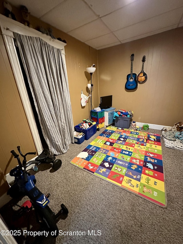 playroom with a drop ceiling and carpet flooring