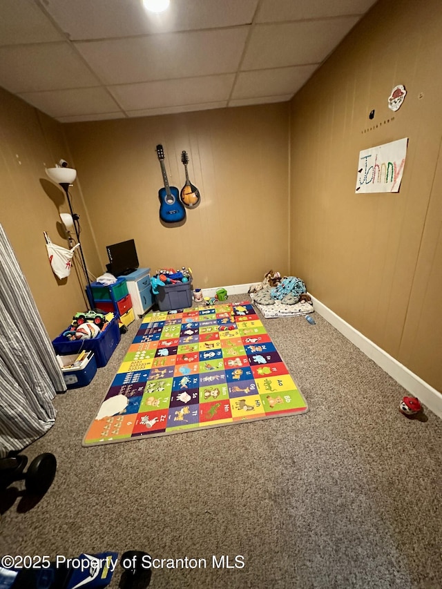 unfurnished bedroom with a drop ceiling and carpet flooring