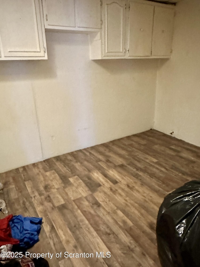 clothes washing area featuring hardwood / wood-style flooring