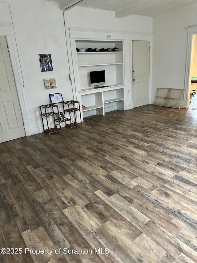 unfurnished living room featuring dark hardwood / wood-style floors