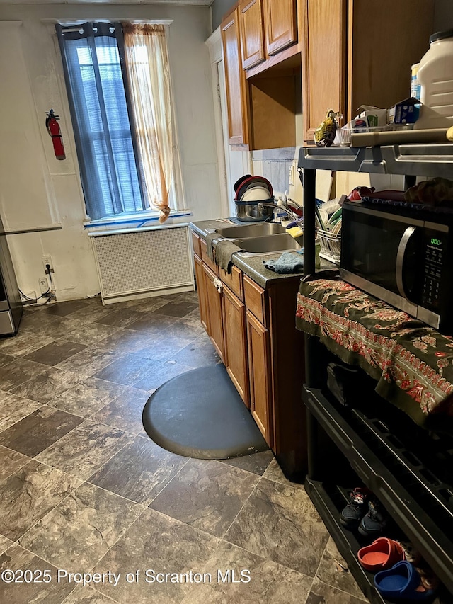 kitchen with radiator heating unit and sink