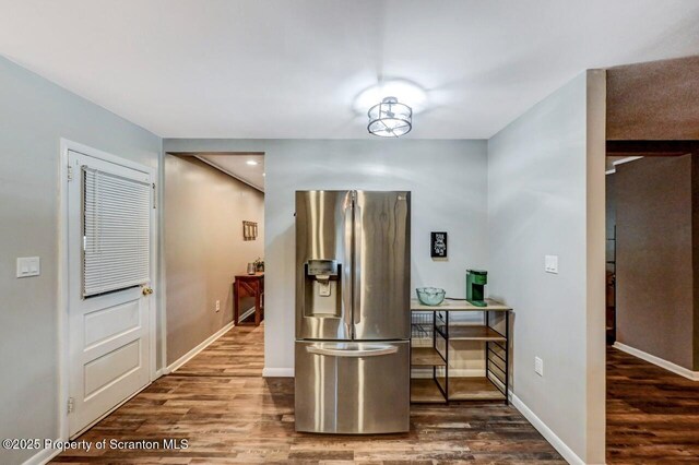 hall featuring wood finished floors and baseboards