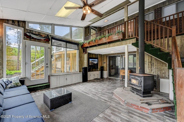 sunroom / solarium featuring ceiling fan