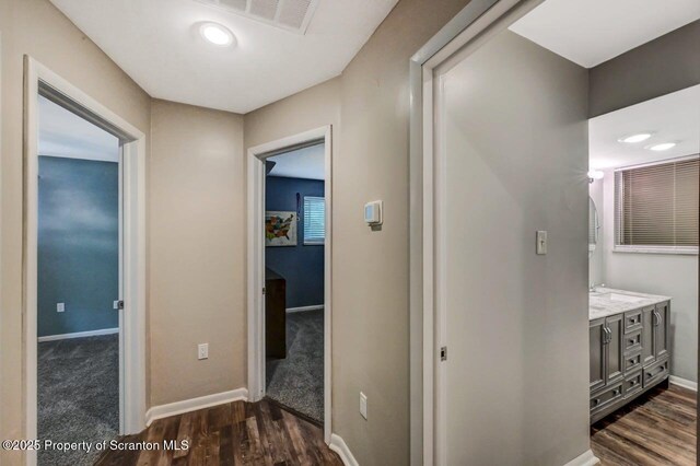 hall with baseboards and dark wood-style floors