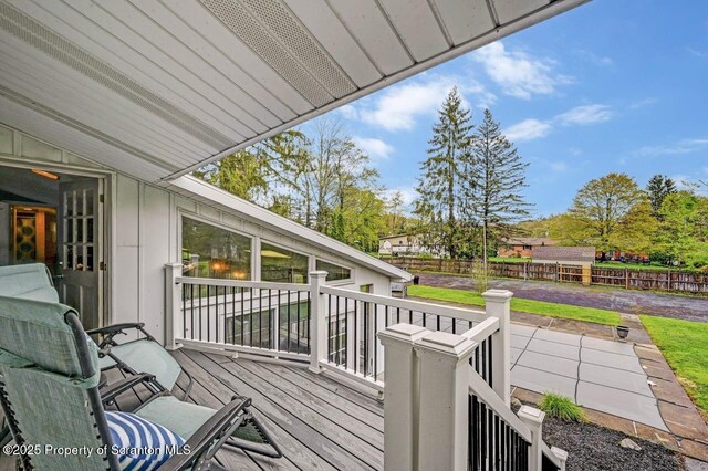 wooden terrace featuring fence
