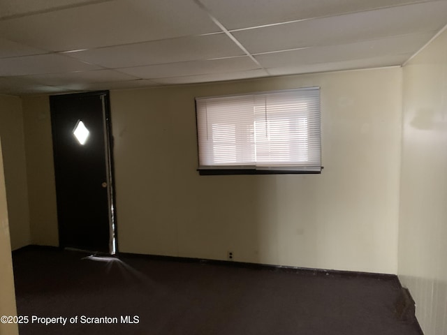 unfurnished room featuring a drop ceiling