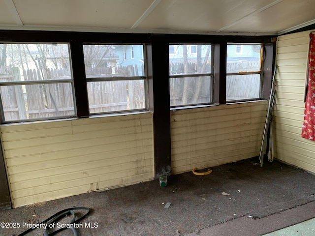 unfurnished sunroom featuring a healthy amount of sunlight