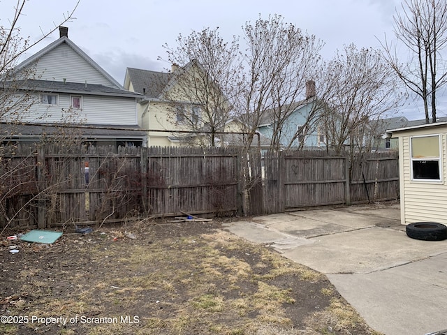 view of yard with fence and a patio