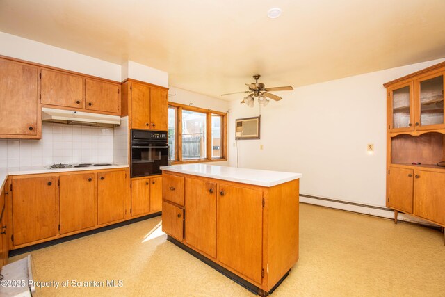 517 Emmett St, Scranton, PA 18505 - kitchen featuring black oven, under cabinet range hood, decorative backsplash, ceiling fan, and light countertops