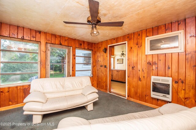 517 Emmett St, Scranton, PA 18505 - living area with heating unit, carpet floors, plenty of natural light, a ceiling fan, and wooden walls