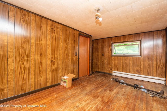 517 Emmett St, Scranton, PA 18505 - unfurnished room featuring a baseboard radiator, wood-type flooring, and wooden walls
