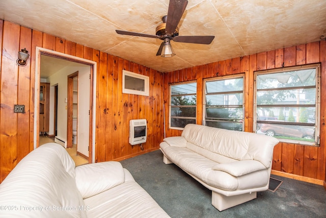 517 Emmett St, Scranton, PA 18505 - living room with heating unit, wood walls, carpet floors, a ceiling fan, and baseboard heating