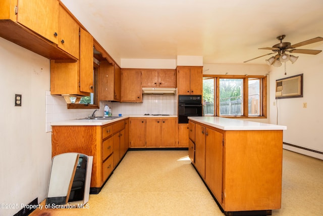 517 Emmett St, Scranton, PA 18505 - kitchen featuring black oven, light countertops, tasteful backsplash, and under cabinet range hood