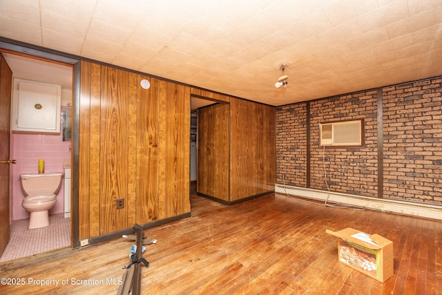 517 Emmett St, Scranton, PA 18505 - empty room featuring wood-type flooring, wooden walls, and a wall mounted AC