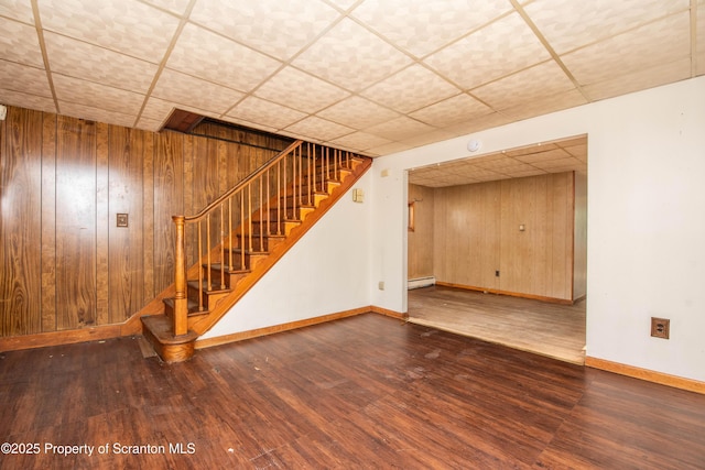 517 Emmett St, Scranton, PA 18505 - finished basement with a baseboard heating unit, a paneled ceiling, wood finished floors, wooden walls, and stairway
