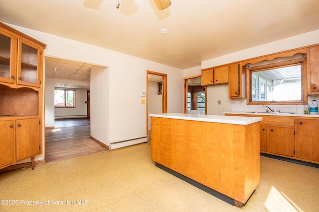 517 Emmett St, Scranton, PA 18505 - kitchen featuring a baseboard heating unit, light countertops, a kitchen island, ceiling fan, and brown cabinets