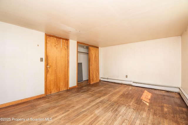 517 Emmett St, Scranton, PA 18505 - unfurnished bedroom featuring hardwood / wood-style flooring, a closet, and a baseboard radiator