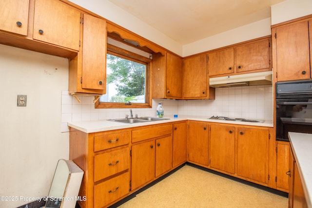 517 Emmett St, Scranton, PA 18505 - kitchen with black oven, under cabinet range hood, tasteful backsplash, and stovetop