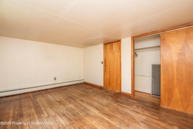 517 Emmett St, Scranton, PA 18505 - unfurnished bedroom featuring a baseboard heating unit and wood-type flooring
