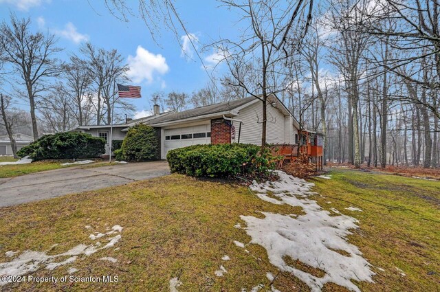 view of home's exterior with a yard and a garage