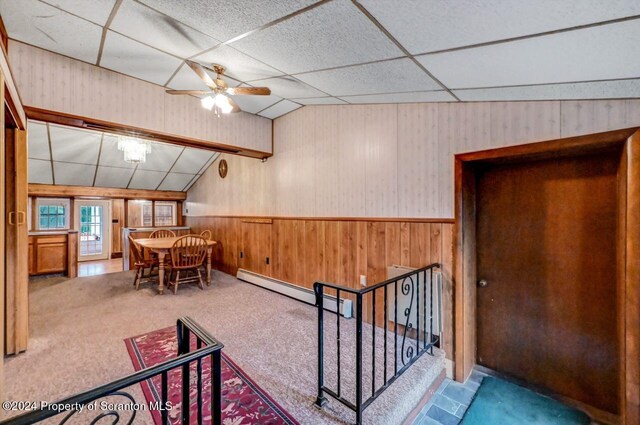 interior space featuring carpet, ceiling fan, lofted ceiling, and a baseboard heating unit