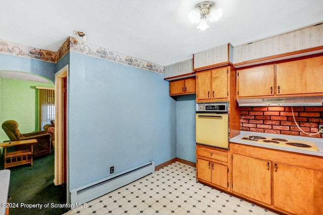 kitchen with a baseboard radiator and white appliances