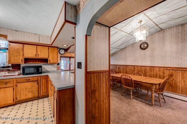 kitchen featuring a chandelier, pendant lighting, and a baseboard heating unit