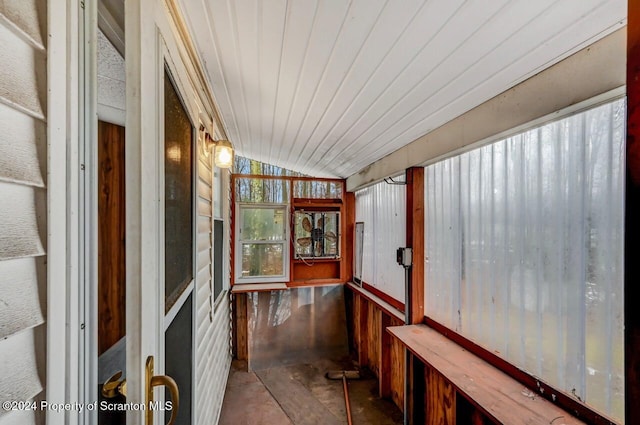 corridor featuring lofted ceiling